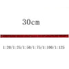A red aluminium triangular scale ruler marked in centimeters, showing various scale ratios.