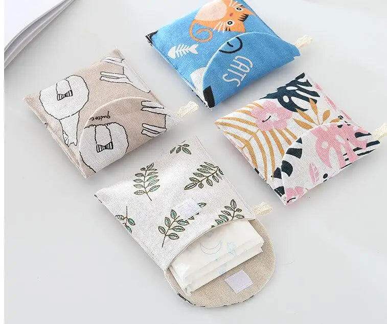 A collection of fabric cosmetic storage pouches featuring various patterns and designs like cats, leaves, and abstract shapes