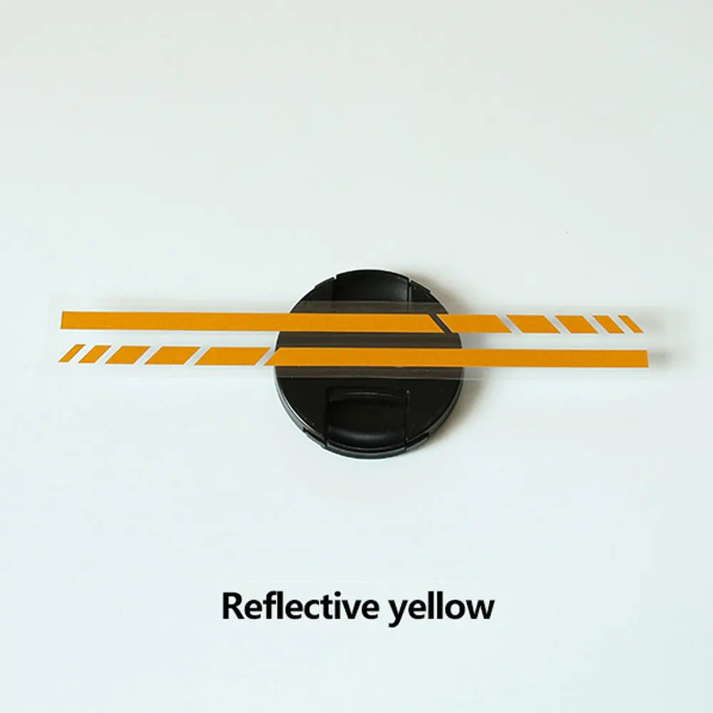 A black circular decal with horizontal reflective yellow stripes on a white background.