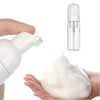 A white pump dispenser bottle of foaming soap next to a hand holding a blob of white soap cream.