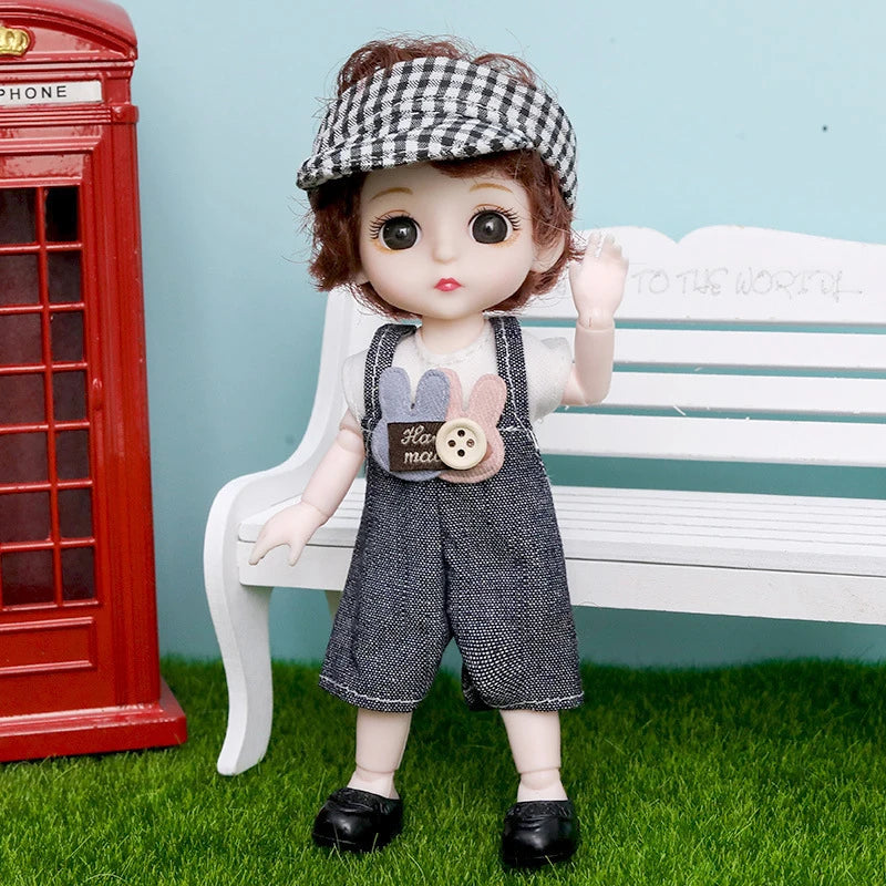 A fashion doll with brown hair wearing a checkered headband and overalls sitting on a white bench.