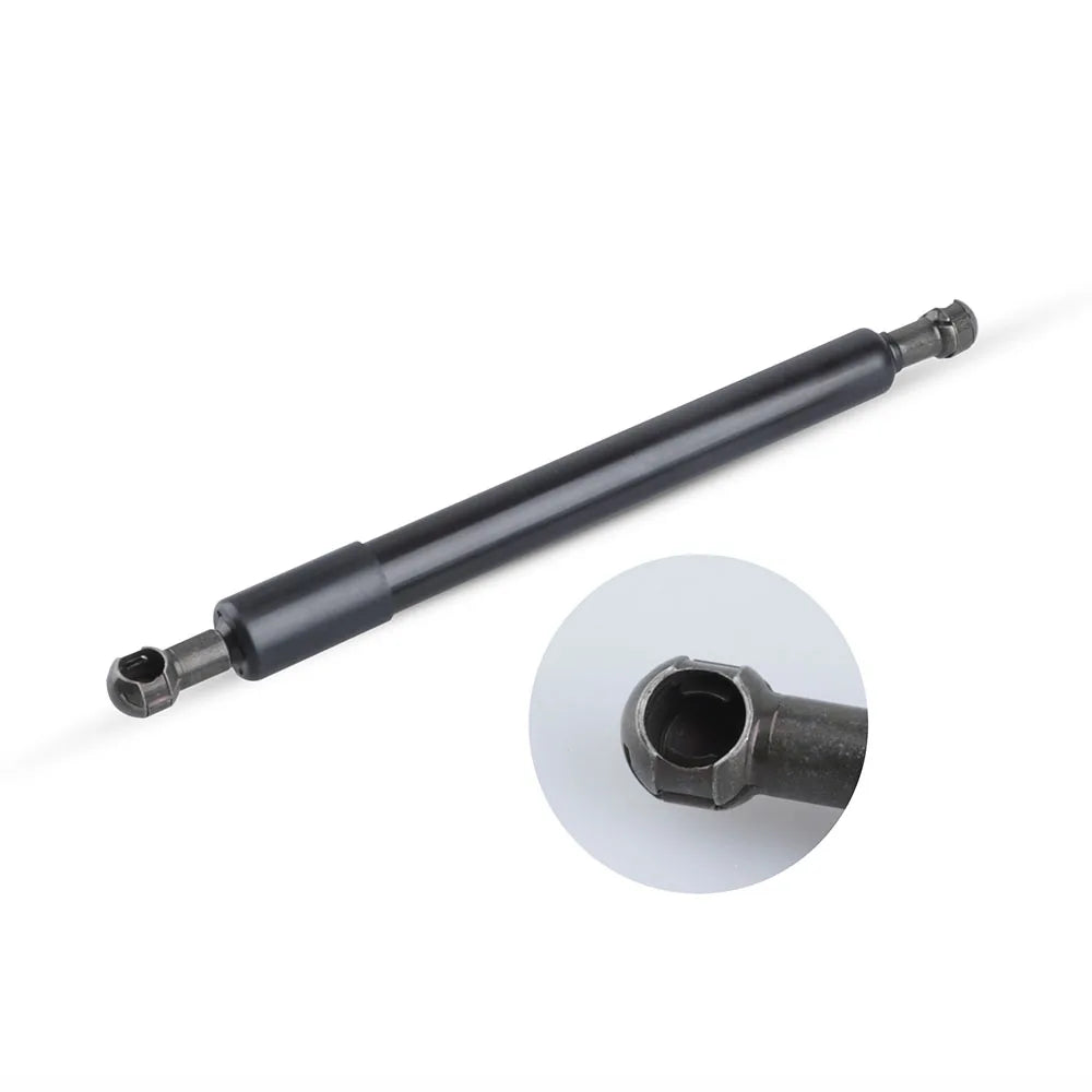 A black gas spring tailgate strut with a threaded end and a hexagonal fitting is shown against a white background.
