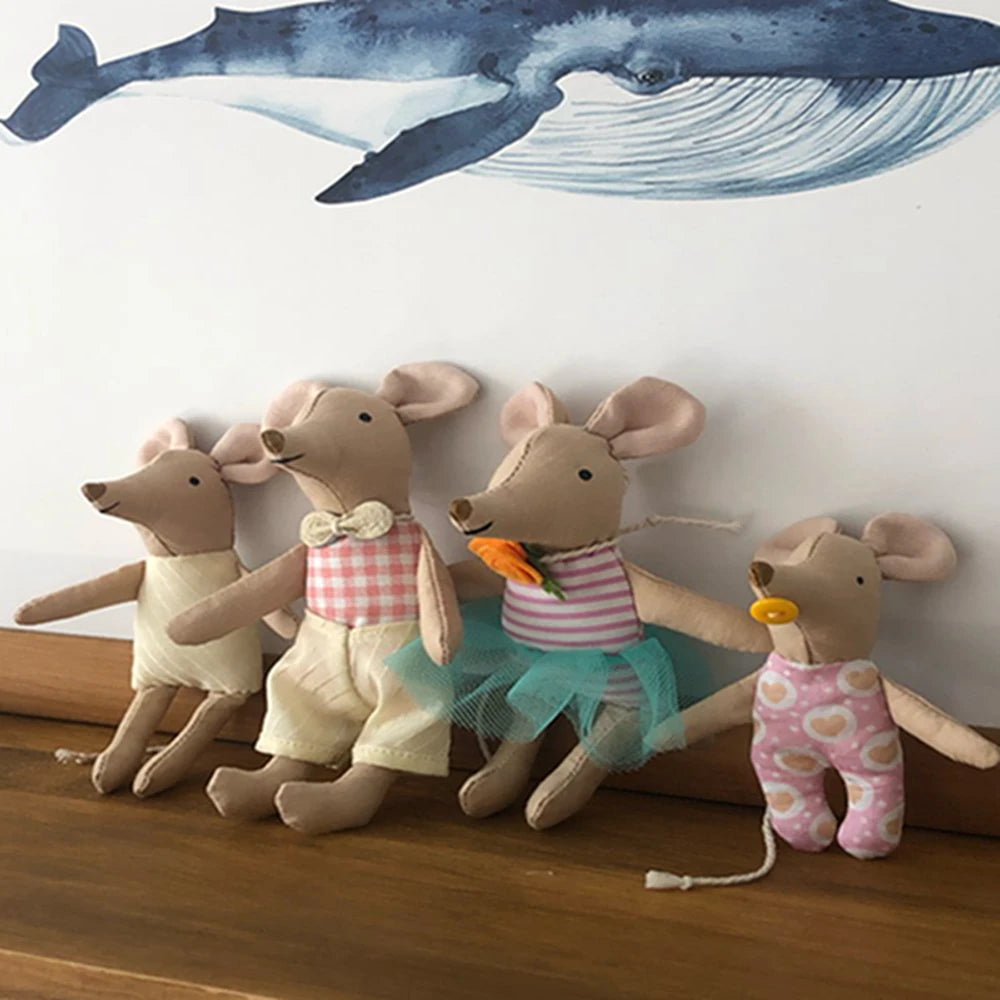 A group of adorable stuffed deer toys in various outfits and colors displayed against a white wall.