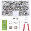 A set of metal snap fasteners and a pair of pliers tool for use in crafting or repair.