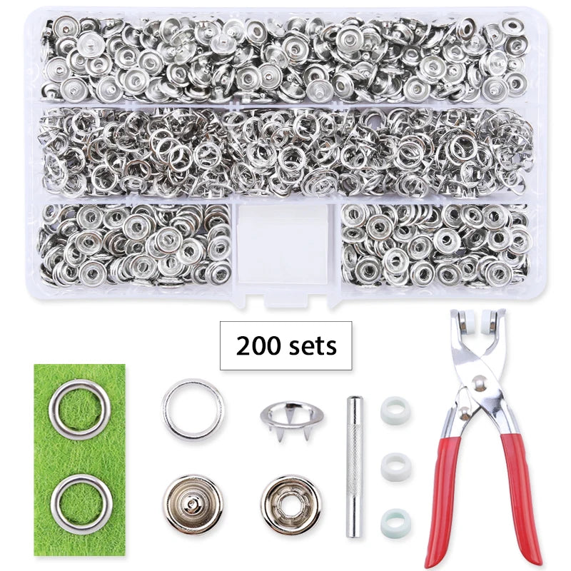 A set of metal snap fasteners and a pair of pliers tool for use in crafting or repair.
