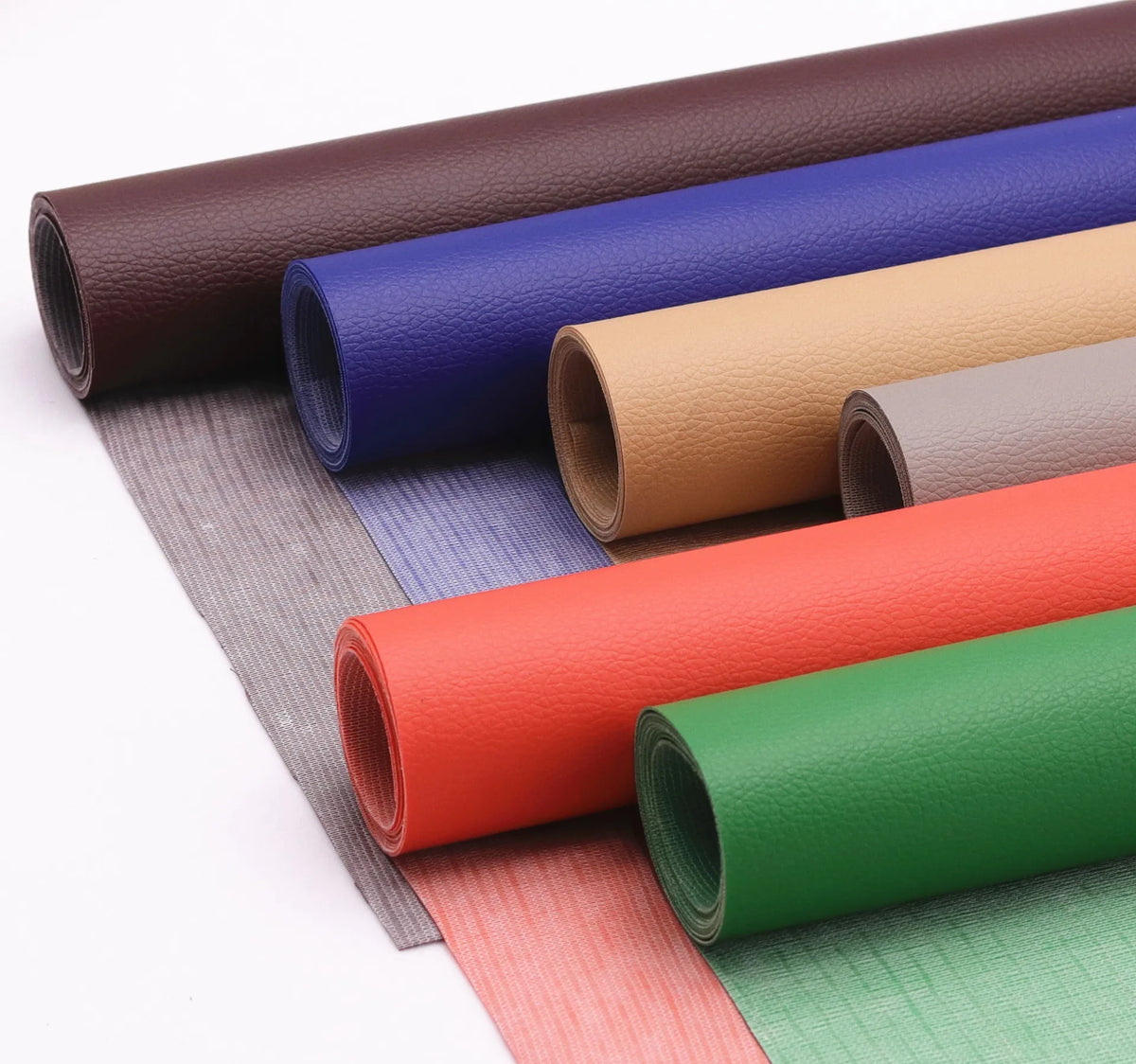Rolls of self-adhesive PU leather patches in various colors including brown, blue, beige, orange, and green.