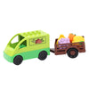 A green toy vehicle carrying colorful fruits and vegetables built from building blocks.
