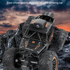 Black four-wheel double steering off-road climbing RC car with HD video camera on a rocky terrain.