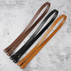 Three adjustable PU leather crossbody bag straps in brown, black, and tan laid diagonally on a white surface.