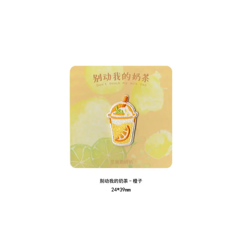 An embroidered iron-on patch featuring a yellow iced tea drink design on a light yellow background.