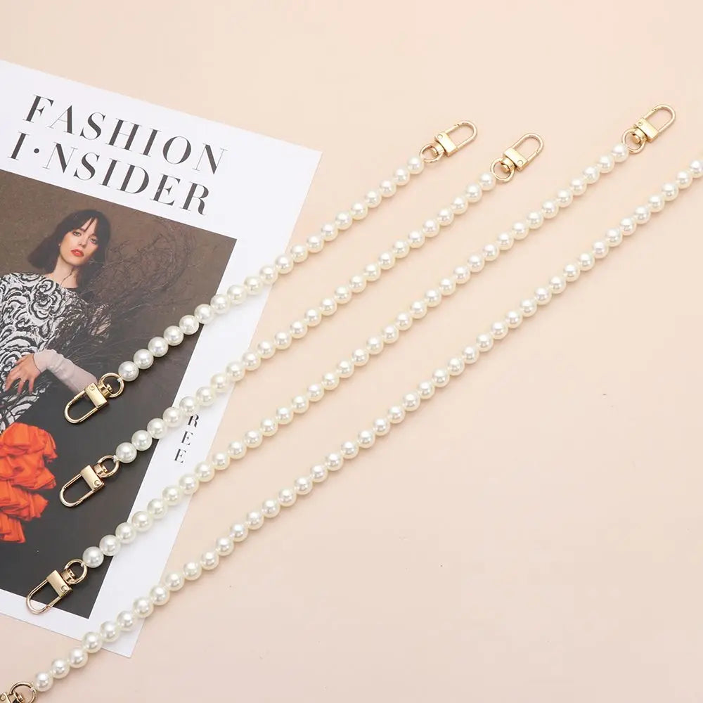 Multiple strands of elegant pearl chains with gold clasps displayed on a light background.