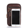 A dark brown vintage leather multi-pocket waist bag holding an iPhone.