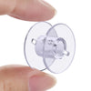 A hand holds a transparent plastic sewing machine bobbin with a metal holder for quilting and embroidery.