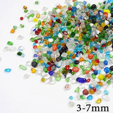 A pile of multi-colored decorative stone pebbles ranging in shades of green, blue, yellow, and red.