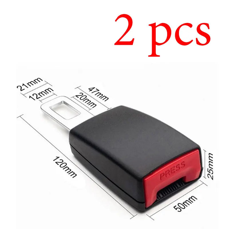 Two black seat belt extenders with metal buckles shown next to a ruler for size reference.