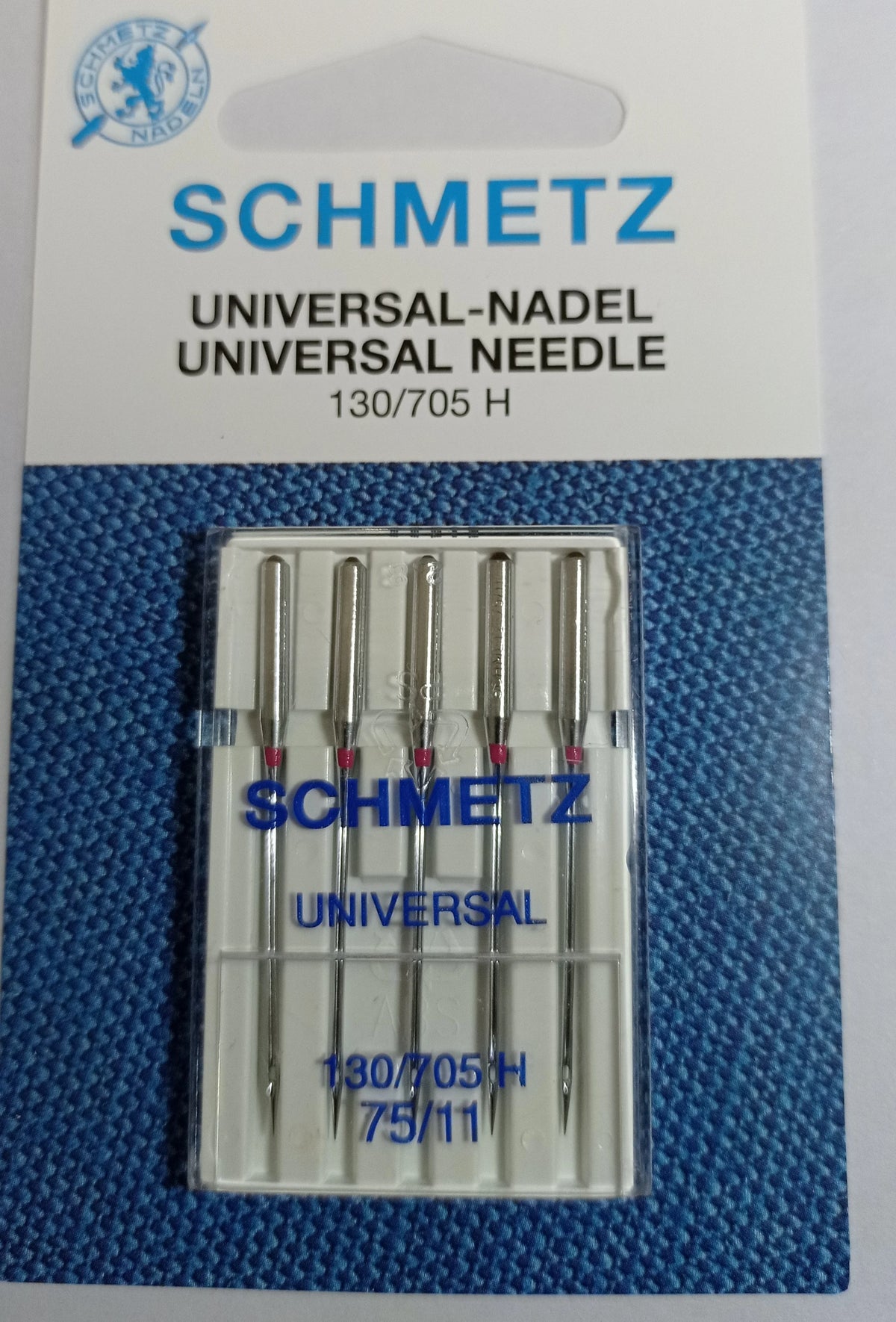 A package of five Schmidt universal sewing machine needles labeled 130/705 H