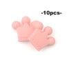 A pile of ten pink silicone crown beads for jewelry making and DIY crafts.