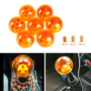 A set of orange star-design shift knobs and mounting hardware for universal sport gear.