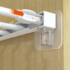 A close-up view of white adhesive shelf support pegs being inserted into a wooden surface.