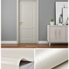 A close-up of a light beige wood grain self-adhesive wallpaper sample roll for doors and furniture.