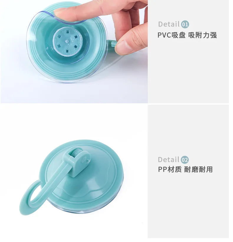 A hand is holding a clear blue suction cup hook, demonstrating its strong vacuum seal and PVC material.