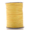 A spool of yellow waxed cotton cord used for jewelry making