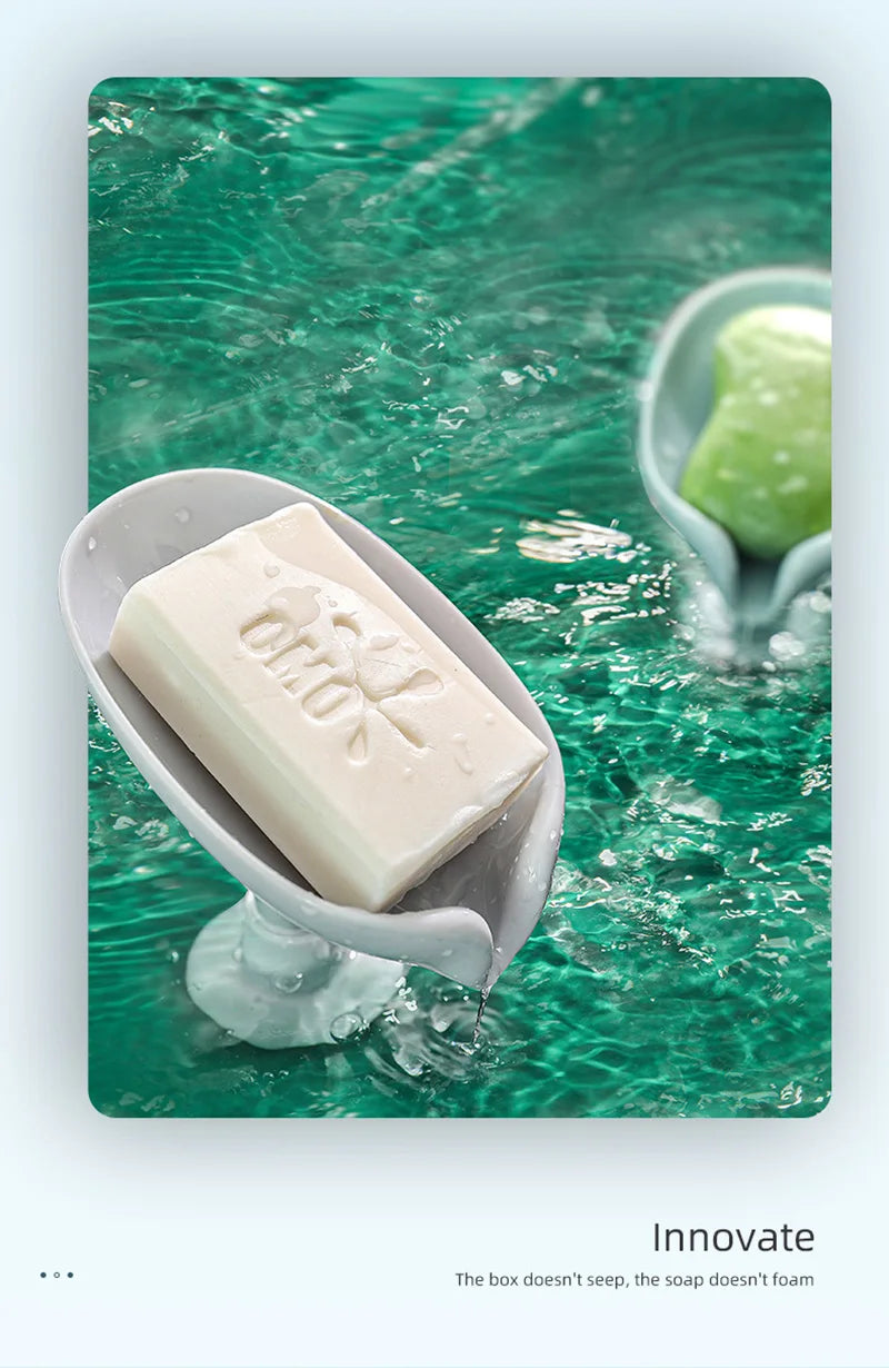 A bar of white soap is dripping into a green, textured water surface in a light gray dish.