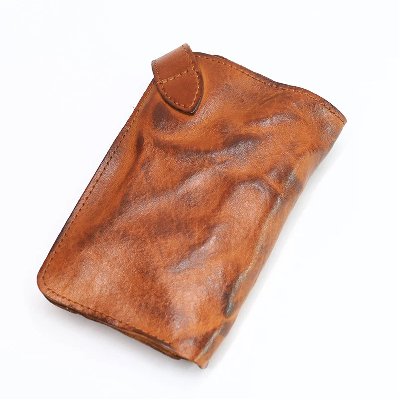 A brown vintage cowhide leather bi-fold wallet for women shown from above.