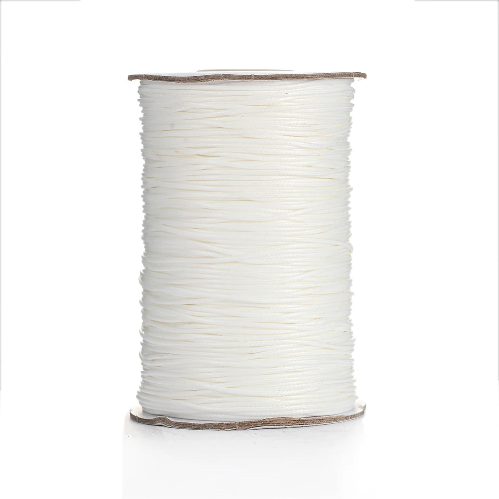 A spool of white waxed cotton cord used for jewelry making.