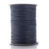 A spool of dark gray waxed cotton cord used for jewelry making