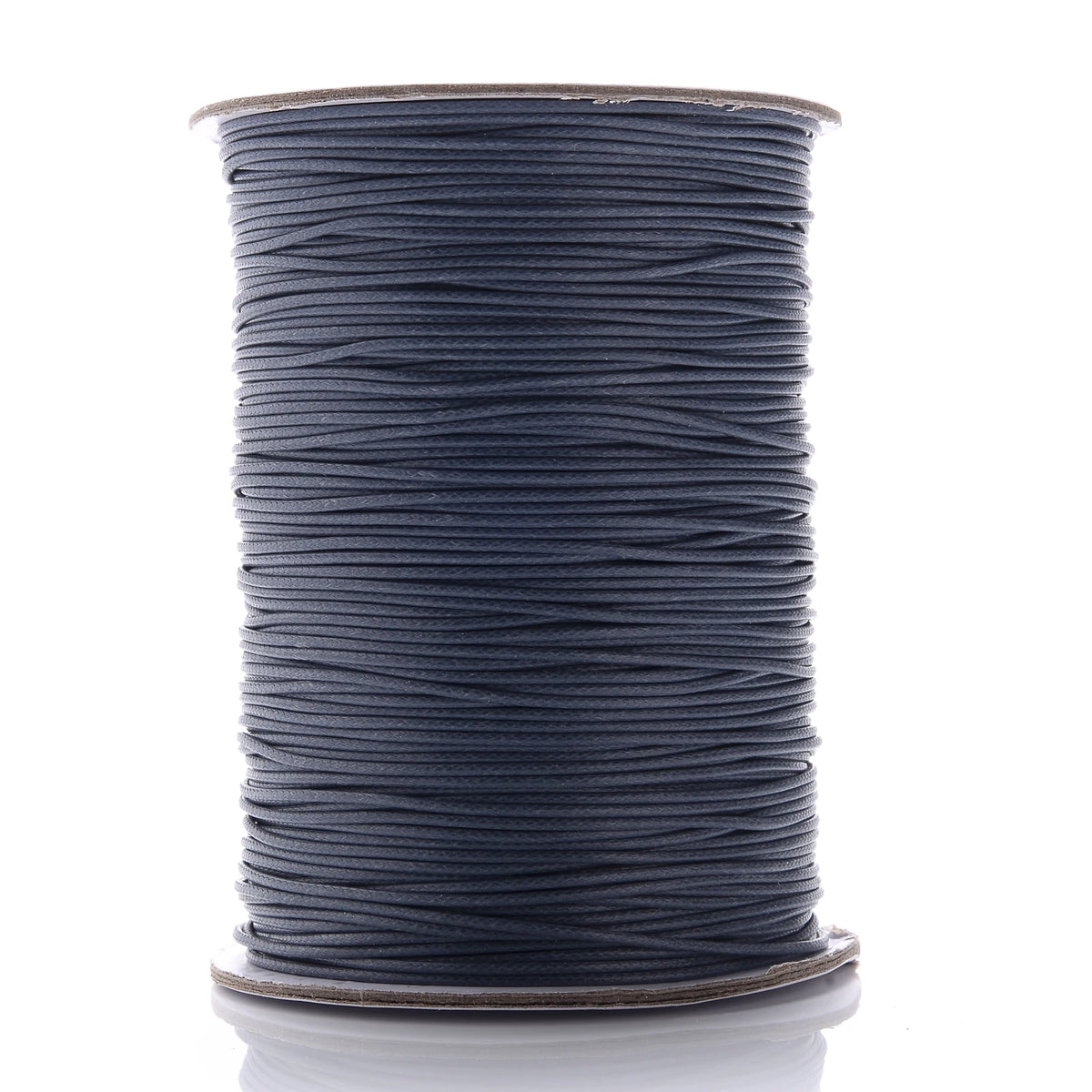 A spool of dark gray waxed cotton cord used for jewelry making