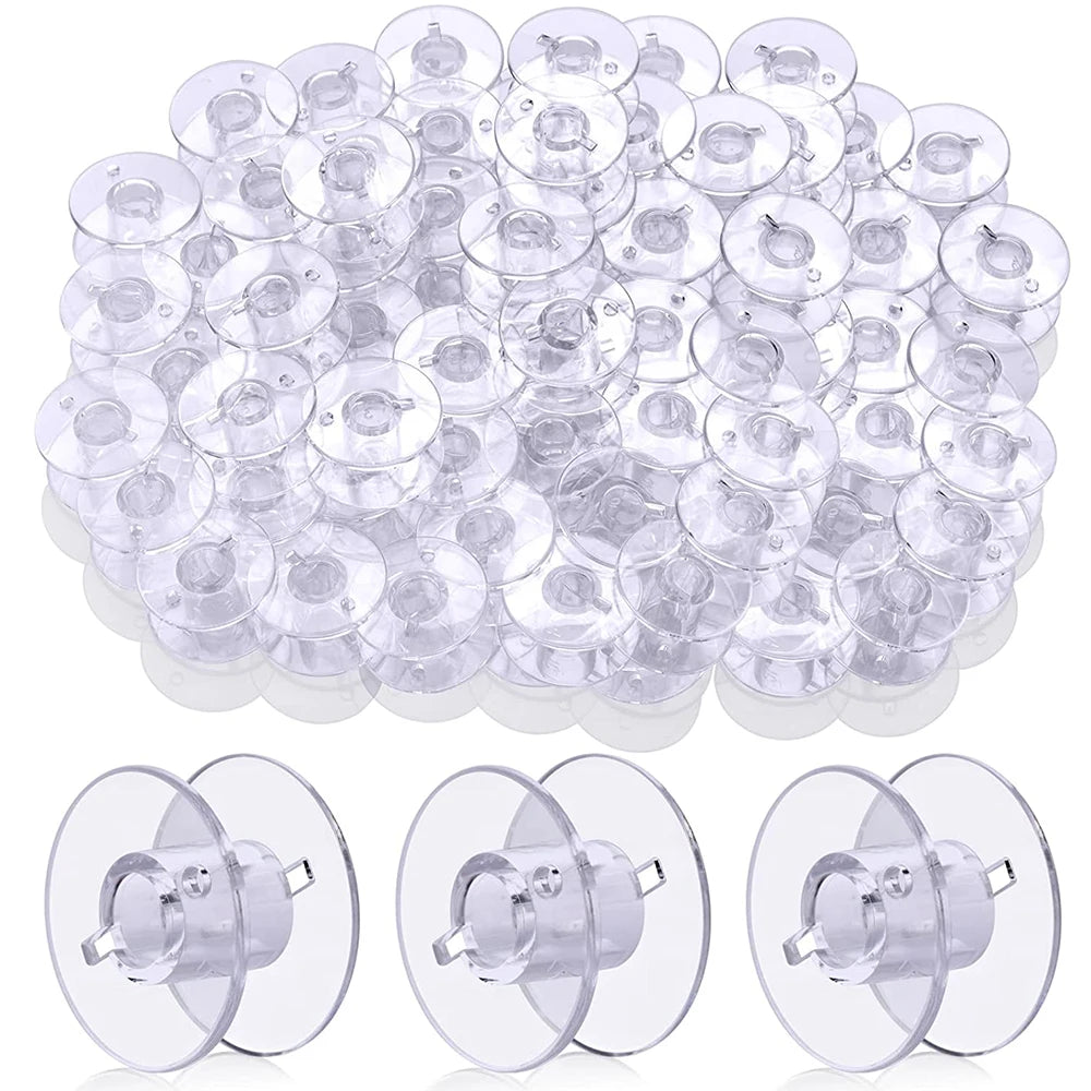 A pile of clear plastic sewing machine bobbins for quilting and embroidery.