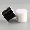 A spool of black elastic crystal beading cord for jewelry making is shown next to a white spool.