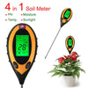 A black soil meter device with an orange tip is shown next to a potted plant.