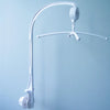 A white musical crib mobile with a rotating rattle bracket suspended from a curved arm.