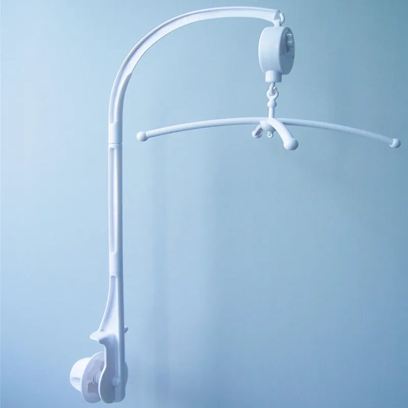 A white musical crib mobile with a rotating rattle bracket suspended from a curved arm.