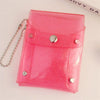 A pink glitter PVC card holder with a fold-over design and a silver chain attached.