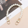 A strand of white pearls on a gold-toned chain strap for handbags or DIY purses.