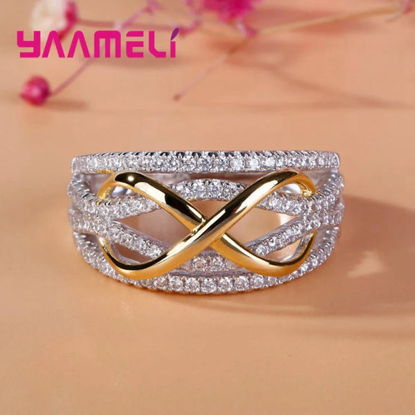 Silver eternity band ring featuring a gold bowknot design and cubic zirconia stones.