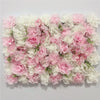 A wall panel covered in pink and white silk rose flowers for weddings and events.