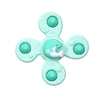 A light mint green suction cup spinner bath toy shaped like a whale for toddlers.