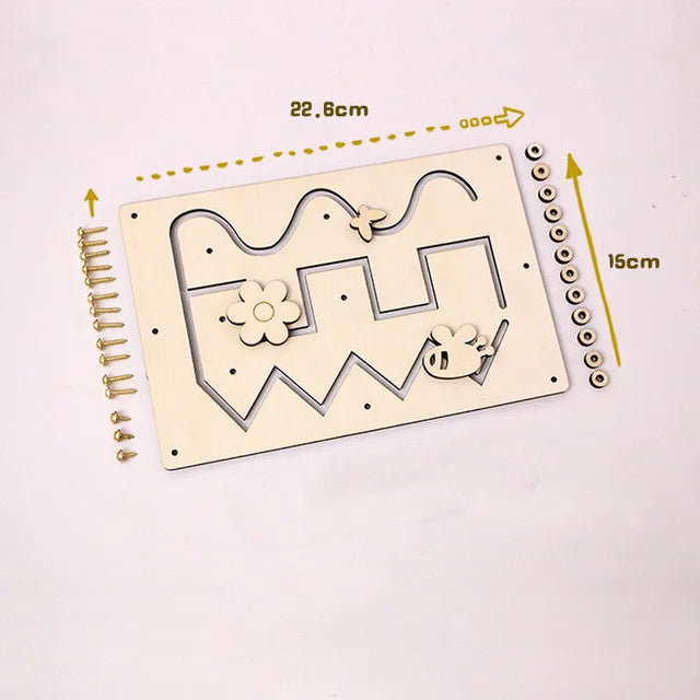 A wooden Montessori busy board with various cutout shapes and small wooden pegs for toddlers.