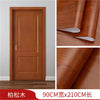 Close-up view of a wooden door panel showing rich wood grain texture and finish.