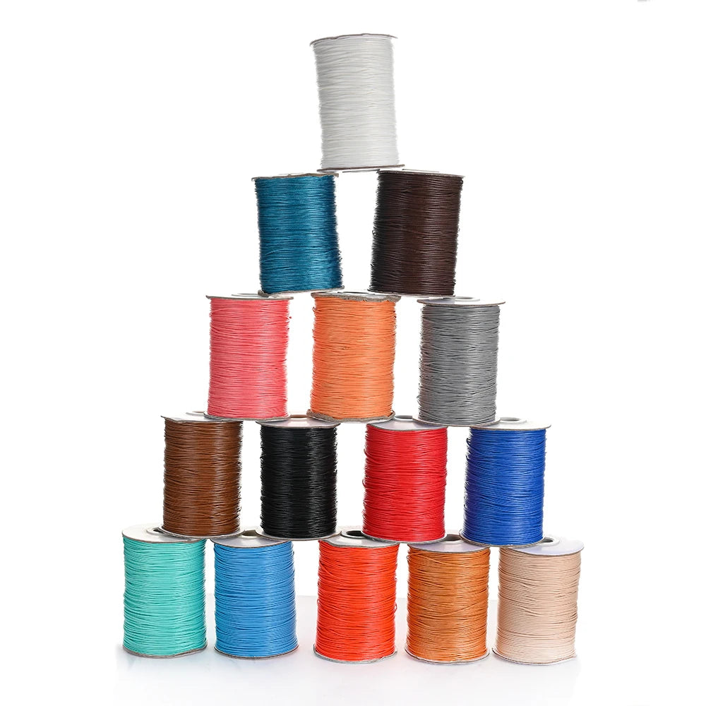 A stack of colorful waxed cotton cord in various shades including blue, green, red, and brown.