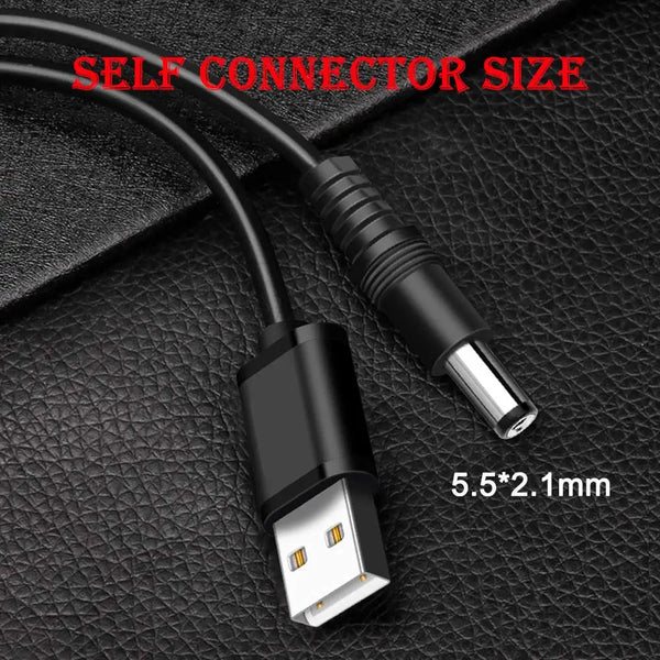 A black USB to DC power cable with a 5.5x2.1mm connector tip is shown on a dark surface.