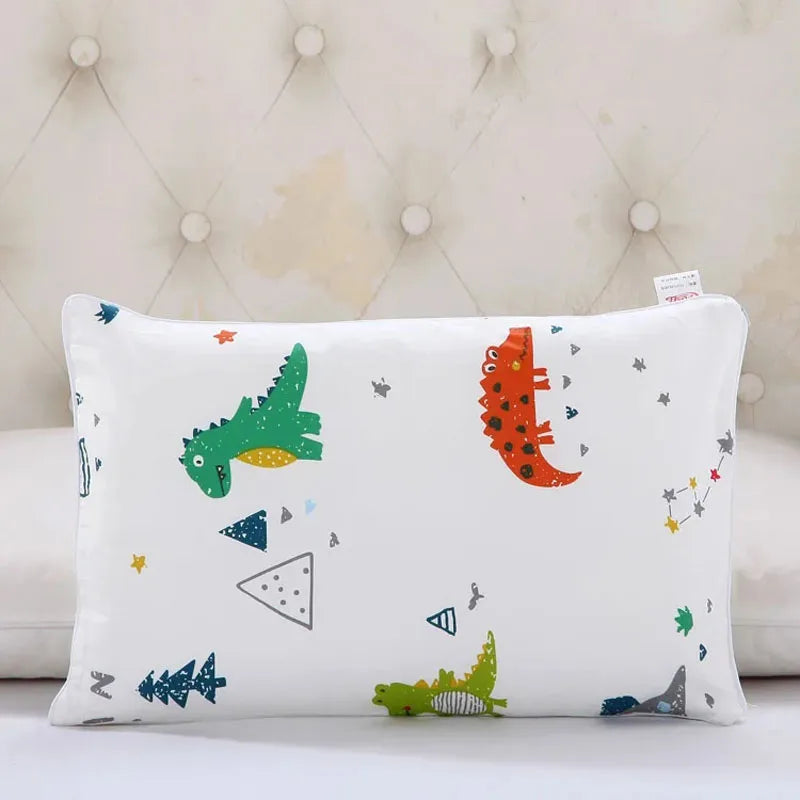 A white cartoon pillowcase featuring various colorful animal and geometric shapes for kids.