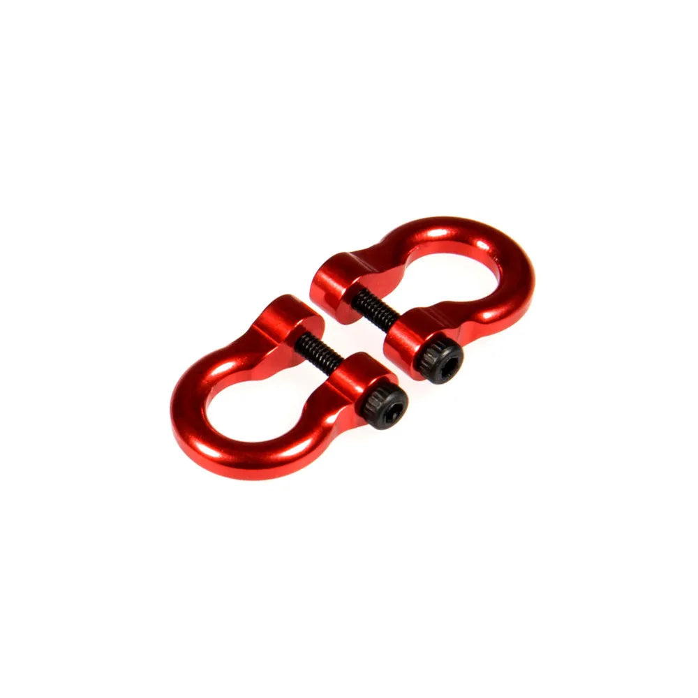 A pair of red metal alloy tow shackles for an RC crawler.
