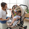 A woman holds a soft plush baby rattle toy with a hanging bell and cartoon animal mobile in a stroller.