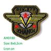 Embroidered US Marine Corps medal patch with yellow wings and red stars on a dark olive green fabric background
