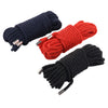 Three bundles of soft silk bondage rope in navy blue, red, and black.